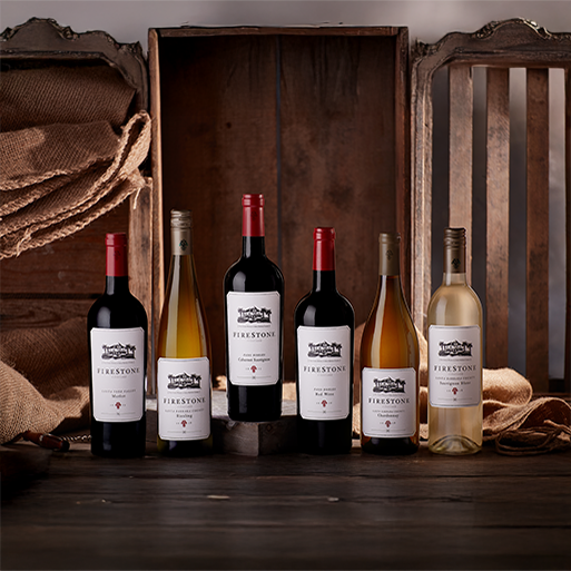 Rustic display of Firestone wine bottles featuring wood, burlap, and natural textures