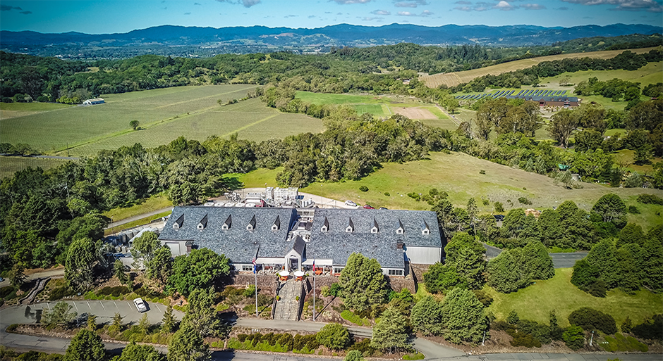 an arial view of Chalk Hill Estate and green rolling hills and mountains in the background
