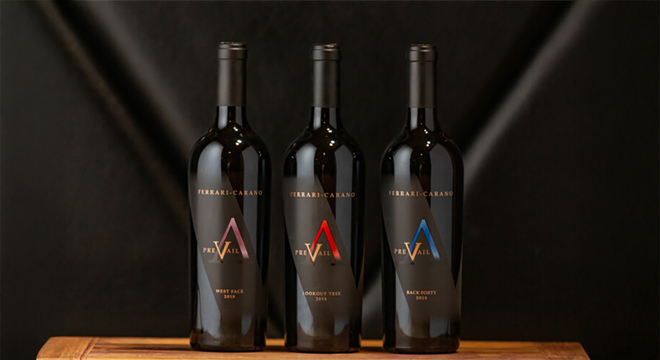 three bottles of PreVail wines on a table against a dark background